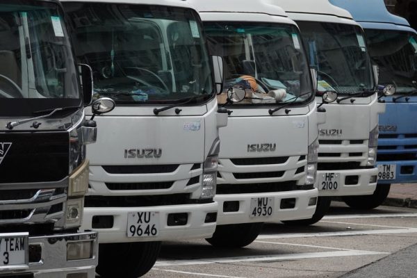 Biển Báo Cấm Xe Tải - Parked Isuzu trucks lined up in the city, ready for delivery. Ideal for transport and logistics themes.